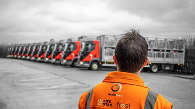A Drainfast worker looks over the fleet of delivery vehicles.