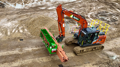 Agetur UK excavator moving SiteStak drainage workstation on a construction site drone photo