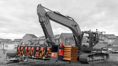 Excavator moving a SiteStak workstation