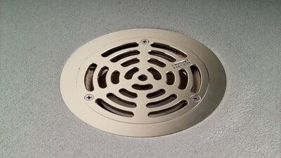 Frost stainless steel drain in a vinyl floor 