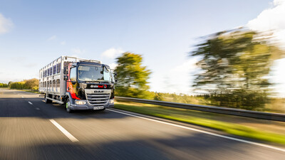 Drainfast truck driving at speed on a road through a beautiful landscape