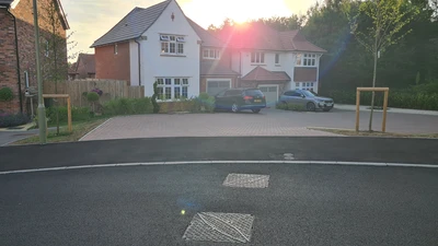 Housing Estate at Golden Hour with Manhole Covers in the road in the foreground