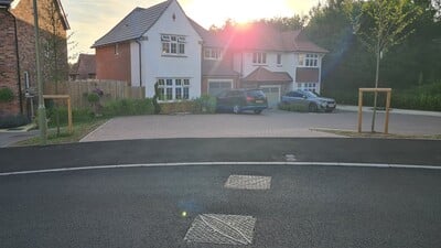 Housing Estate at Golden Hour with Manhole Covers in the road in the foreground